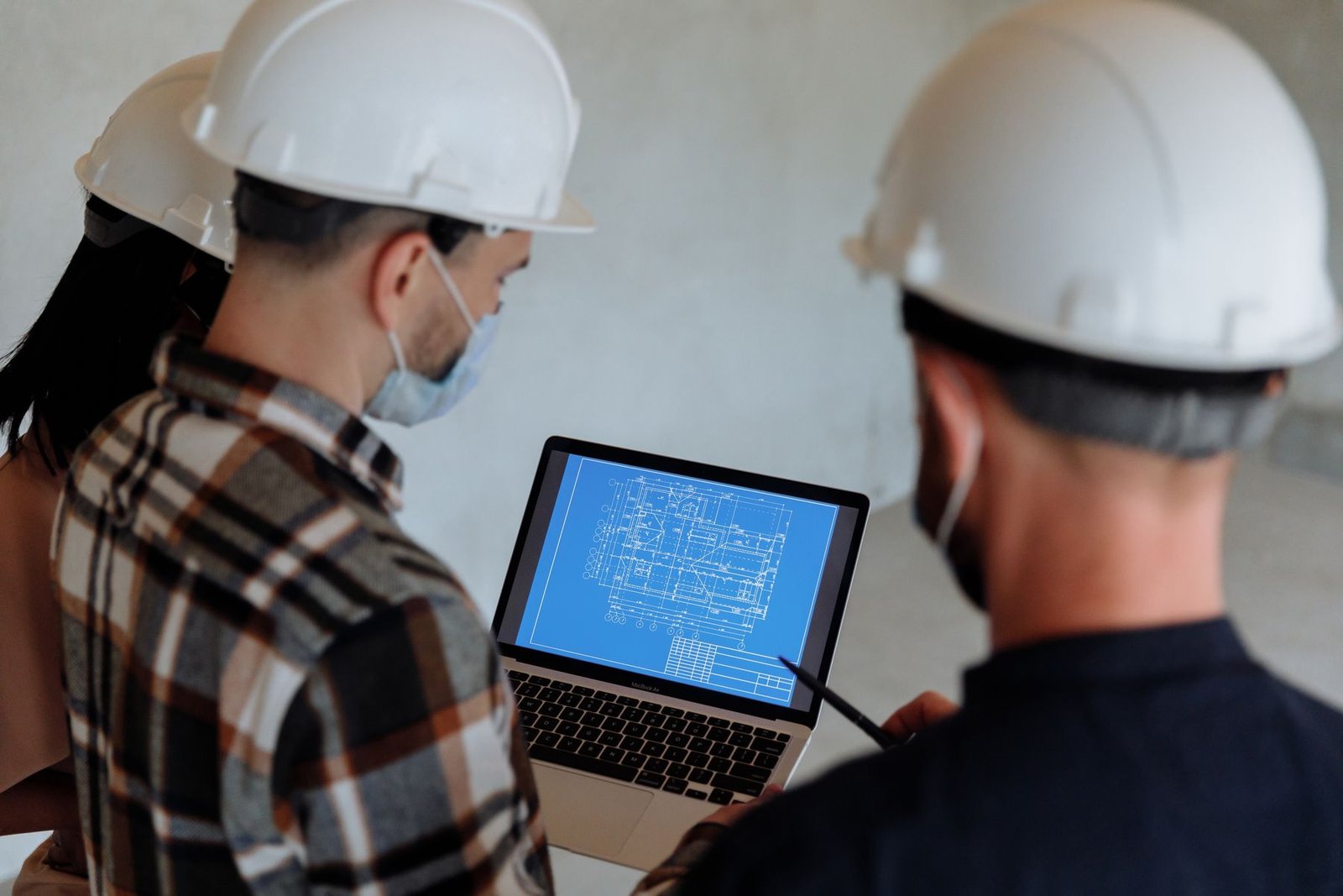 Technical team reviewing a drawing on a laptop
